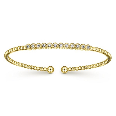 12 round diamonds align in this 14k yellow gold diamond cuff bracelet.