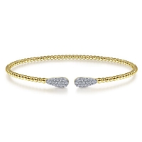 14k yellow gold cable cuff bracelet features two diamond sections.