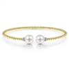 This 14k yellow gold bangle features pearls and diamonds.