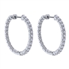 This 14k white gold diamond hoop pair of earrings features nearly 5 carats of round brilliant diamonds in this large and eye catching pair of eaarings.