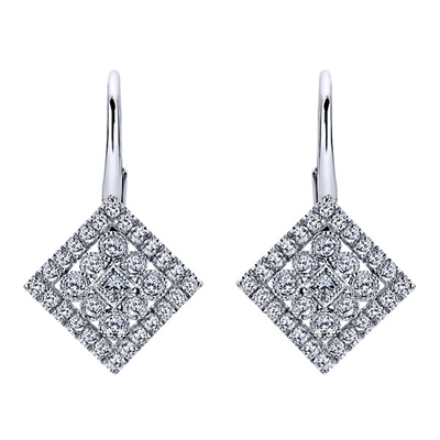 Rows of diamond shine surround a centerpiece of a bezel set round diamond in this 14k white gold pair of diamond drop earrings.