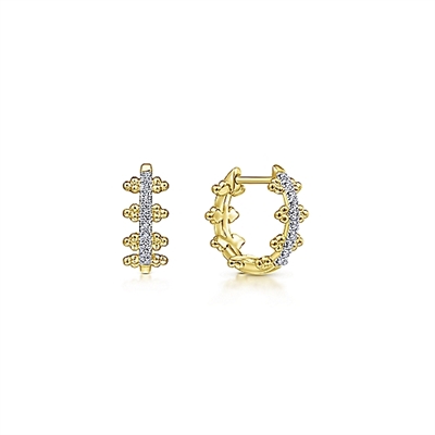 These 14k yellow gold diamond huggie earrings feature 0.10 carats of diamonds.