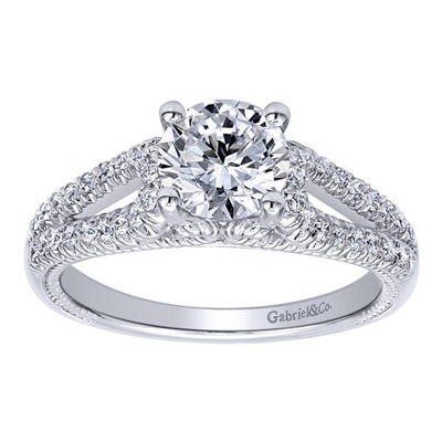 This wonderfully set round diamond split shank diamond engagement ring shimmers and glistens with over one quarter carats of round brilliant diamonds and is offered to you in white gold or platinum.