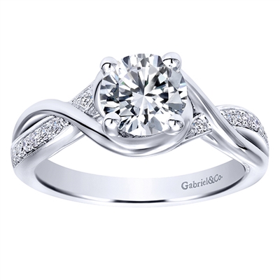 This fresh and modern take on a diamond engagement ring features a split shank to house a round center diamond, in white gold or platinum.