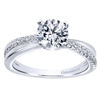 This cool round diamond engagement ring maintains a fresh and contemporary look with a single round diamond row that crosses over sleek white gold or platinum .