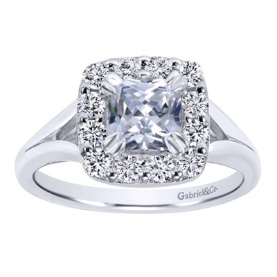 This elegantly crafted white gold or platinum cushion cut diamond halo engagement ring is a head turner and an eye popper, featuring round brilliant diamonds and a semi split shank keeping the excitement of this engagement ring alive!