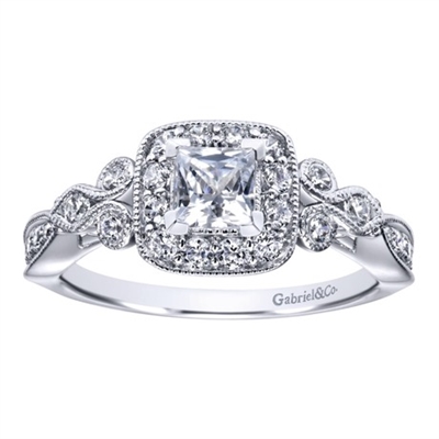 This flowing white gold or platinum princess halo engagement ring shimmers with almost one half carats of round brilliant diamonds, ad its rose-like shank is reminiscent of a flower in bloom.