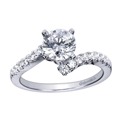 A single diamond row swirls towards a round center diamond in this sleek and stylish white gold or platinum diamond engagement ring.