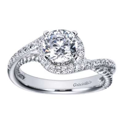 A round center diamond sits warm and cozy in the middle of white gold or platinum bands covered in round brilliant diamonds in this contemporary bypass engagement ring.