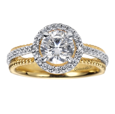 A white gold round brilliant diamond halo pairs with beaded yellow gold bands in this artist inspired two tone contemporary halo engagement ring.