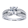 Double bands in white gold or platinum join at the center to cradle a round center diamond of your choice in this vintage style split shank engagement ring, featuring round brilliant diamonds.