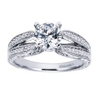 Double bands in white gold or platinum join at the center to cradle a round center diamond of your choice in this vintage style split shank engagement ring, featuring round brilliant diamonds.