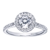 A round brilliant diamond halo sets up a bold round center diamond, accompanied by round brilliant diamonds all along the band of this white gold or platinum contemporary halo engagement ring.