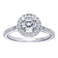 A round brilliant diamond halo sets up a bold round center diamond, accompanied by round brilliant diamonds all along the band of this white gold or platinum contemporary halo engagement ring.
