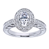 A vintage style halo engagement ring set with nearly one half carats in round brilliant diamonds fabulously decorates an oval shaped center diamond in this engagement ring available in white gold or platinum.