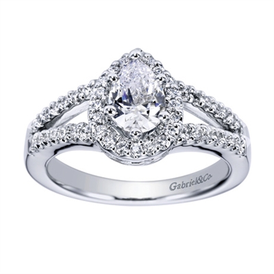 A center pear diamond sits perfectly in this split shank white gold or platinum contemporary halo engagement ring with round brilliant diamonds.