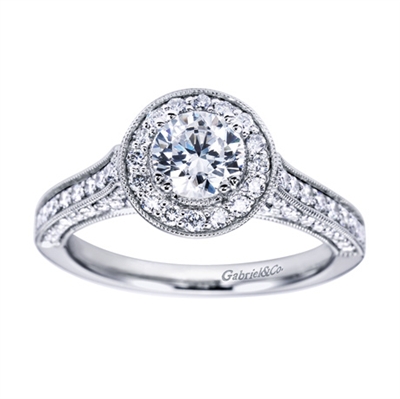 Featured in white gold and available in platinum, this wittily crafted vintage style halo engagement ring contains over one half carat in round brilliant diamonds.