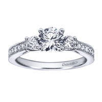 A classic 3 stone approach with a taste of the dramatic in its milgrain edging, this white gold or platinum vintage 3 stone engagement ring will light her eyes up with 12 carat of round brilliant diamonds.