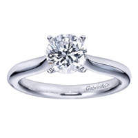 Simplicity at its finest, this smooth band thoughtfully cradles a round center diamond in a sturdy 4 prong setting in this solitaire engagement ring.