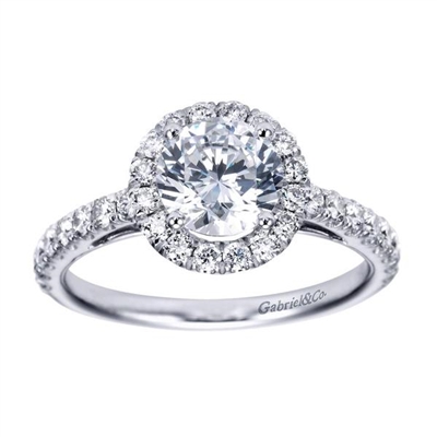 Gorgeous and stunning, this round diamond halo engagement ring cradles a round center diamond in its shimmering diamond halo with over one half carats in diamonds.  Enjoy the artful metalwork along the sides of this round diamond halo engagement ring.