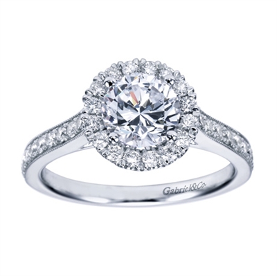 A milgrain finish with round brilliant diamonds make this contemporary halo engagement ring a refreshing and uplifting choice.