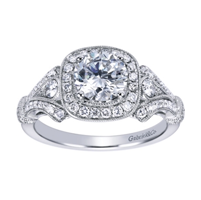 A well crafted and intricately designed vintage inspired halo engagement ring with round brilliant diamonds fitting a round center diamond of your choice.