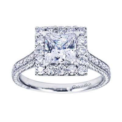 Round diamonds join a square engagement ring setting in white gold or platinum in this contemporary princess halo engagement ring.