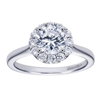 This stylish and unique solitaire style halo engagement ring boasts top qulaoty round brilliant diamonds all surrounding a shimmering round center diamond fo your choice.