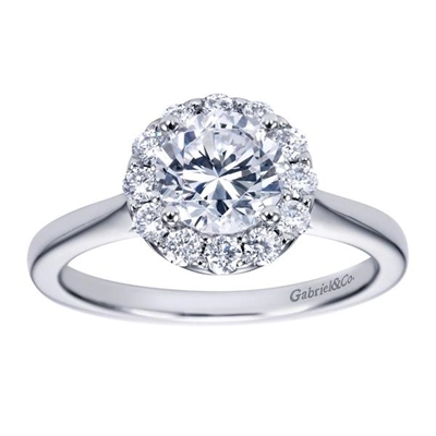 This stylish and unique solitaire style halo engagement ring boasts top qulaoty round brilliant diamonds all surrounding a shimmering round center diamond fo your choice.