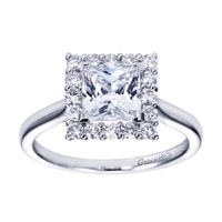 A stylish white gold or platinum band meets a round brilliant diamond halo holding a princess cut center diamond in this contemporary halo engagement ring.