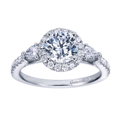 A uniquely designed contemporary halo engagement ring with round and pear diamonds surrounding an immaculate center diamond of your choice, engagement ring designed by Gabriel & Co.