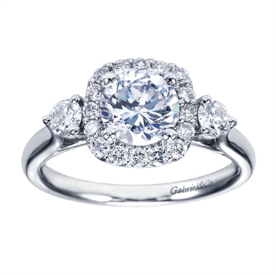 A Gabriel & Co. designer engagement ring that is very unique, this white gold 3 stone style halo engagement ring is sparkling with a half carat of round brilliant diamonds, including two larger side diamonds that really steal the show.