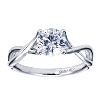 A swirling design engages your eyes upwards towards a round center stone in this subtle and well crafted contemporary solitaire engagement ring.