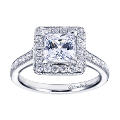 White Gold and round brilliant diamonds converge in this contemporary halo engagement ring by Gabriel & Co.