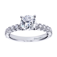 Round prong set brilliant diamonds lift this contemporary straight engagement ring designed by Gabriel & Co.