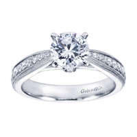 A modern day take on a victorian style engagement ring with round brilliant diamonds.