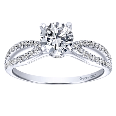This rounded split shank engagement ring benefits from the glow of a round center diamond, featuring almost one quarter carats of round brilliant diamonds, available in white gold or platinum.