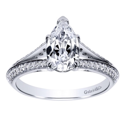 This diamond encrusted engagement ring holds a pear cut center diamond and holds 1/3  carats of round diamonds in its split shank diamond engagement ring setting.