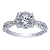 This unique and well crafted vintage style halo engagement ring features a split shank full of round brilliant diamonds and includes a round center diamond!