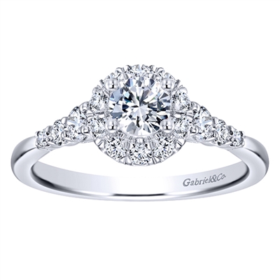 This white gold diamond engagement ring comes with a round center diamond and a beautiful round diamond halo to hold in all that shine!