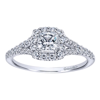 A center princess cut diamond sits snugly in a round diamond halo with a split shank setting in this clever 14k white gold diamond halo engagement ring.