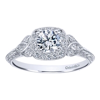 This vintage style diamond engagement ring showcases a decorated halo with an included round center diamond flashing brilliantly in the middle of this artistic diamond engagement ring.
