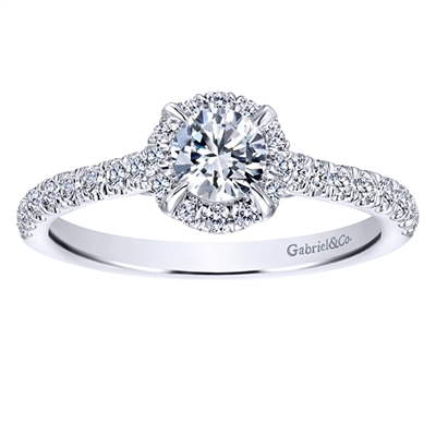 This stunning round diamond halo engagement ring features nearly one full carat of round diamonds and is included with a center diamond!