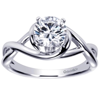 This twisted and clever solitaire engagement ring features a criss cross engagement ring shows off and highlights a round center diamond.