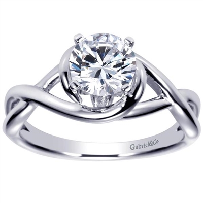 This twisted and clever solitaire engagement ring features a criss cross engagement ring shows off and highlights a round center diamond.