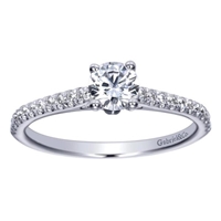 This stunning showcase favorite includes a round center diamond alongside side round diamonds, delivering the glimmer.