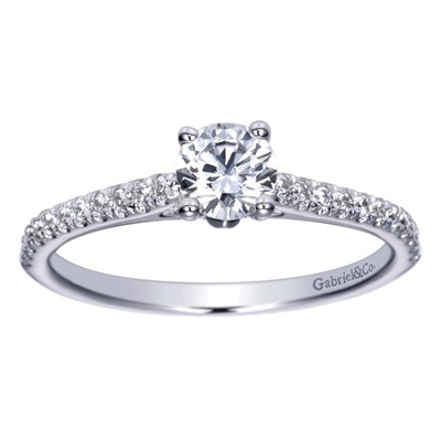 This stunning showcase favorite includes a round center diamond alongside side round diamonds, delivering the glimmer.