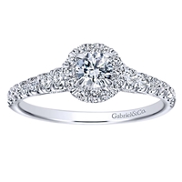 Round brilliant diamonds shine their way up towards a round diamond halo, all capped off with an included round center diamond, in this 14k white gold diamond halo engagement ring.