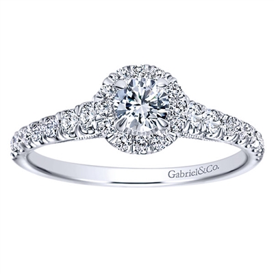 Round brilliant diamonds shine their way up towards a round diamond halo, all capped off with an included round center diamond, in this 14k white gold diamond halo engagement ring.