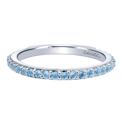 A row of blue topaz stones shine in this 14k white gold stackable ring.
